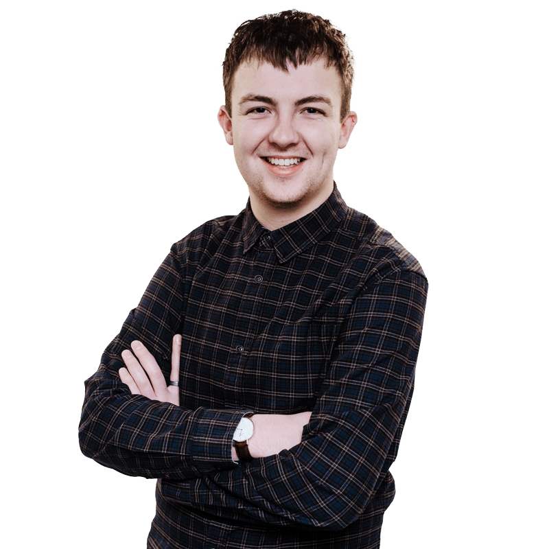 Male student with arms folded smiling at the camera