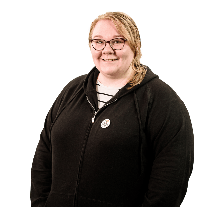 Blonde haired female student wearing black jumper, smiling at camera