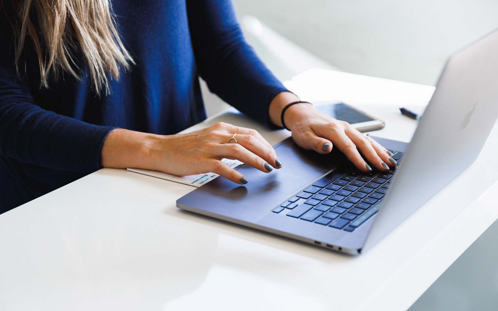 Close up of person typing on laptop keyboard