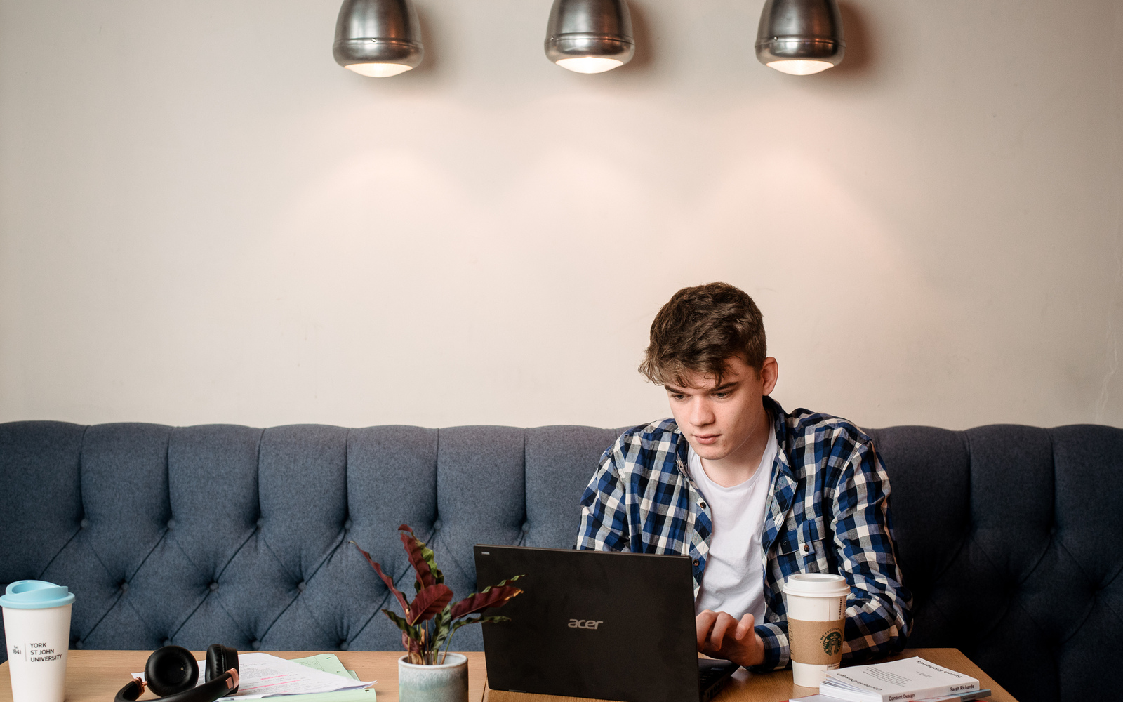 Student sitting alone on laptop