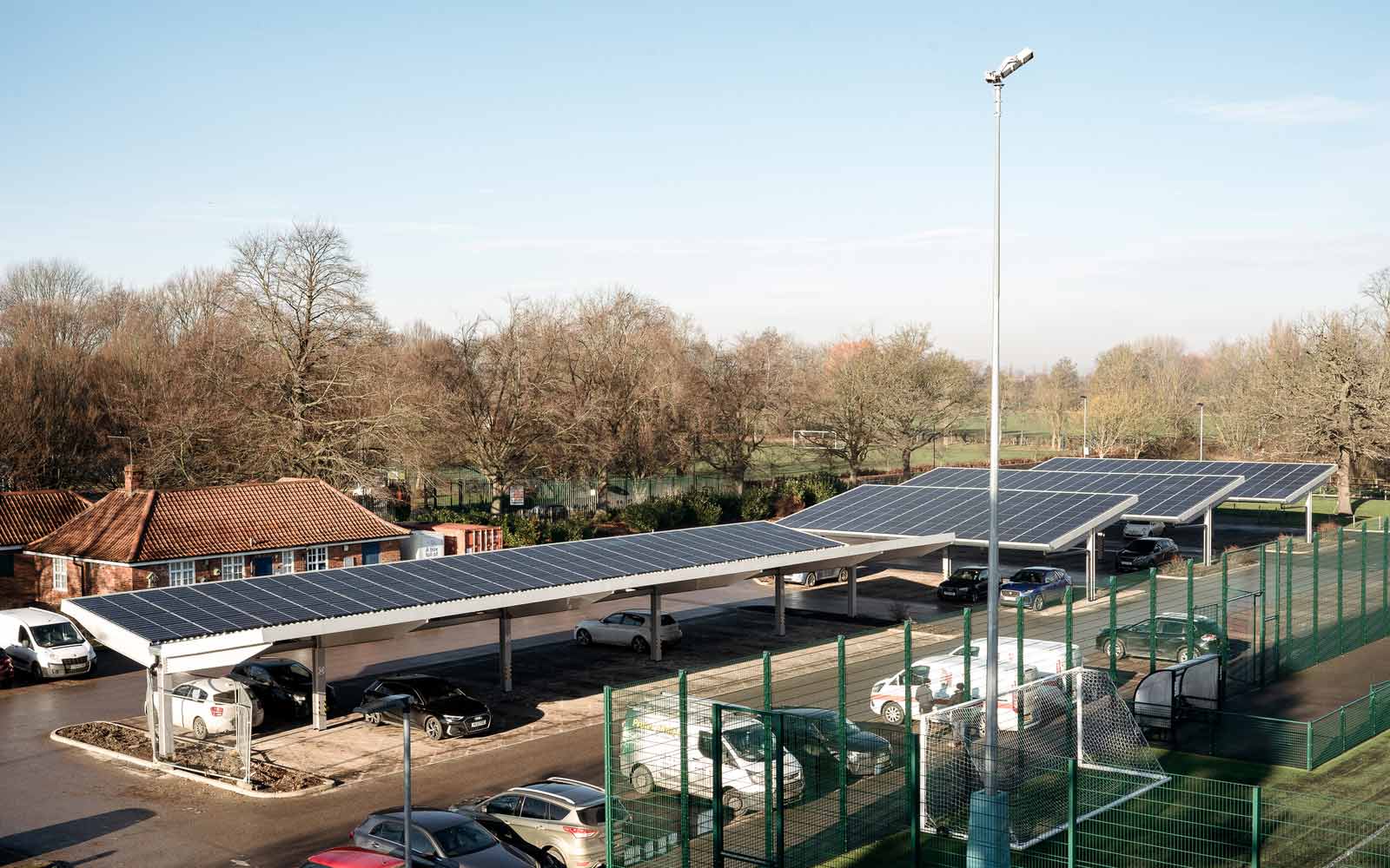 Arrays of solar panelled car park shelters at York St John University.