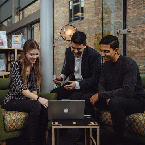 Group of students looking at laptop