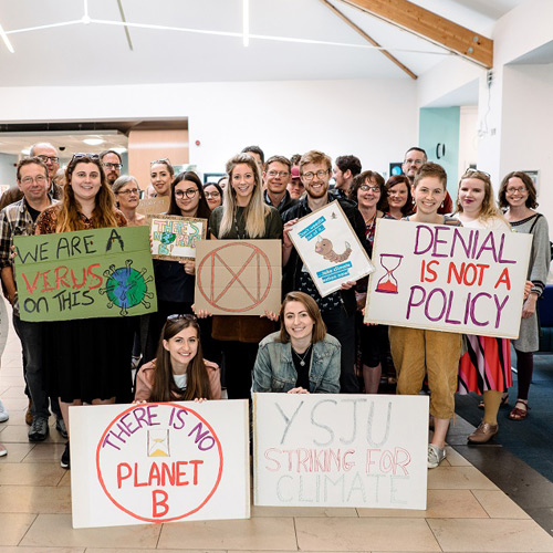 York St John students and staff carrying placards for a climate protest