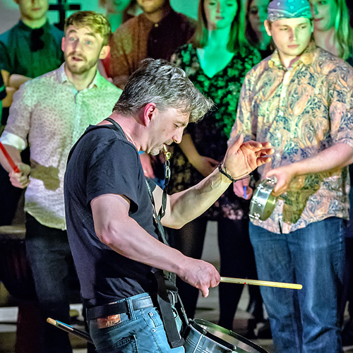 Man playing drum on stage in music concert
