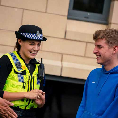 Police officer talking to students