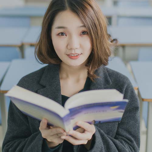 Language teacher holding book in school