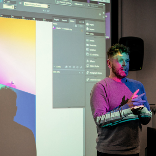 Tutor leading training in Adobe software