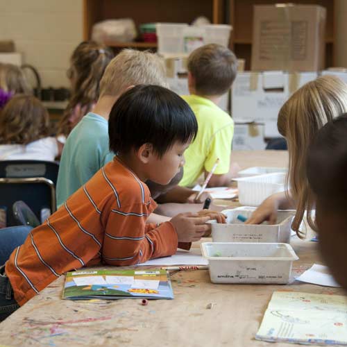 Children working on desk in school setting