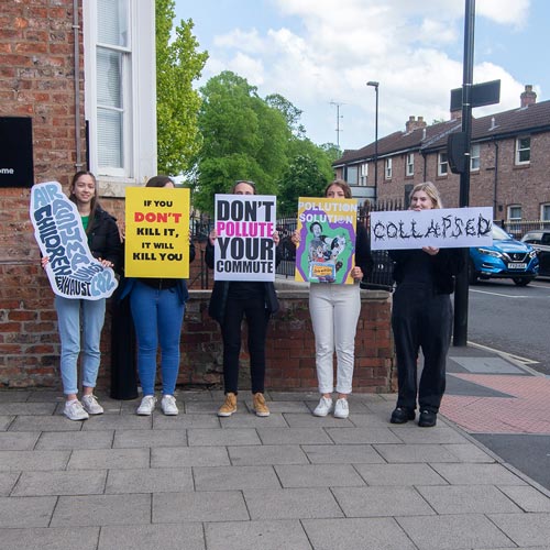 Students with placards protesting against air pollution on York street