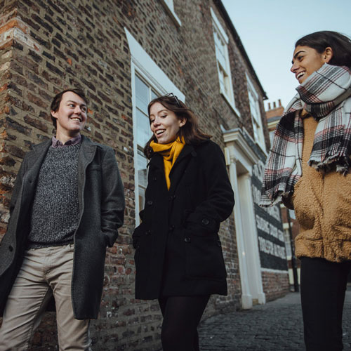 Three students walking in York