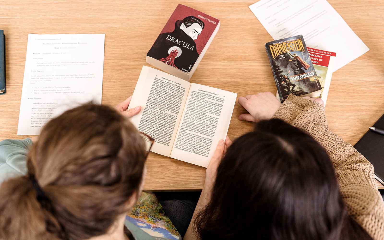 Overhead view of students reading classic texts