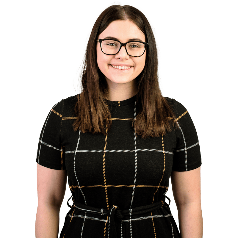 Danielle Paddock, female postgraduate student, brown hair, wearing glasses and smiling facing the camera.